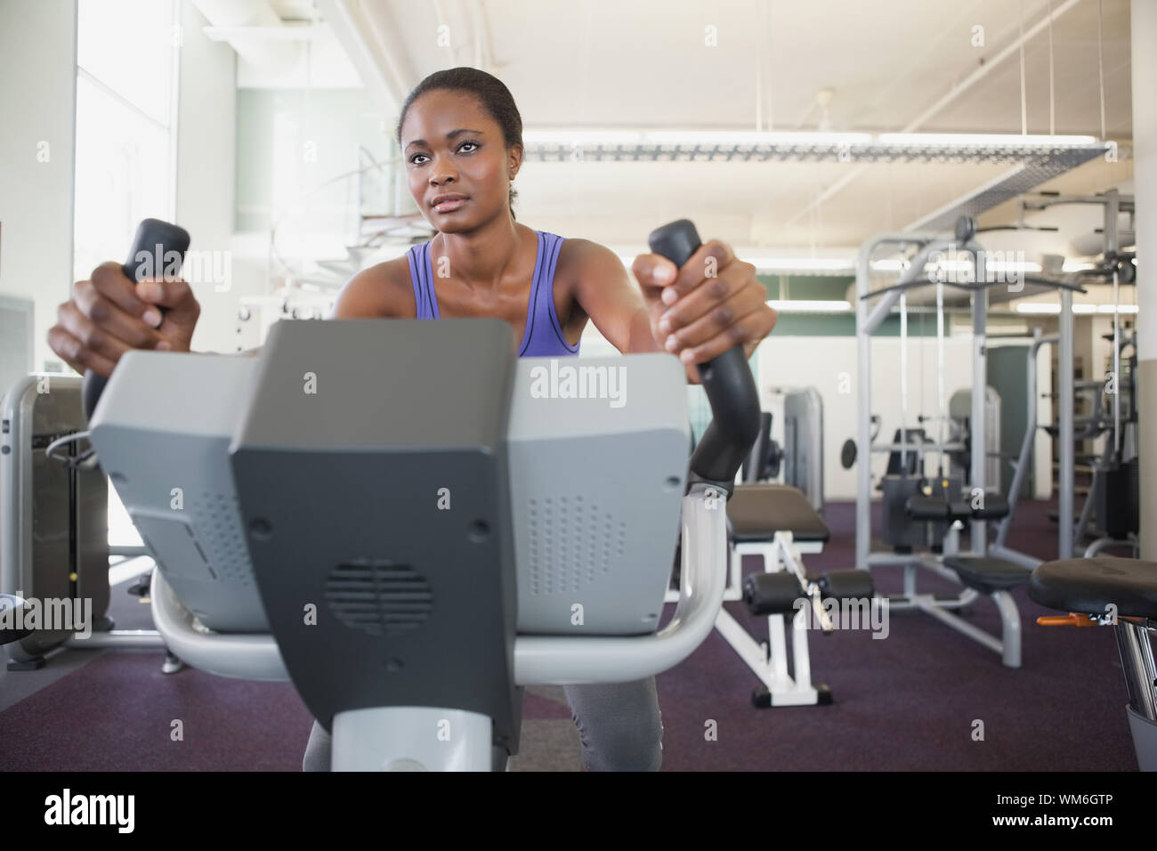 Fit woman working out on the exercise bike at the gym Stock Photo - Alamy