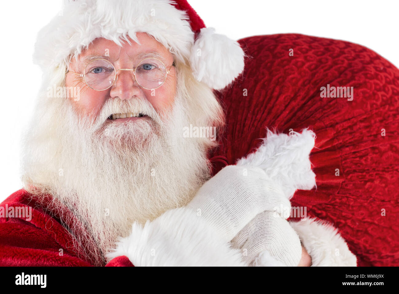 Jolly Santa carries his sack on white background Stock Photo - Alamy