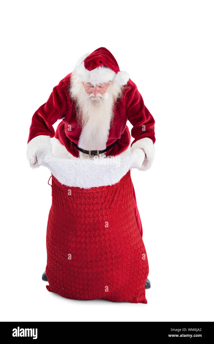 Santa looks in his bag on white background Stock Photo - Alamy