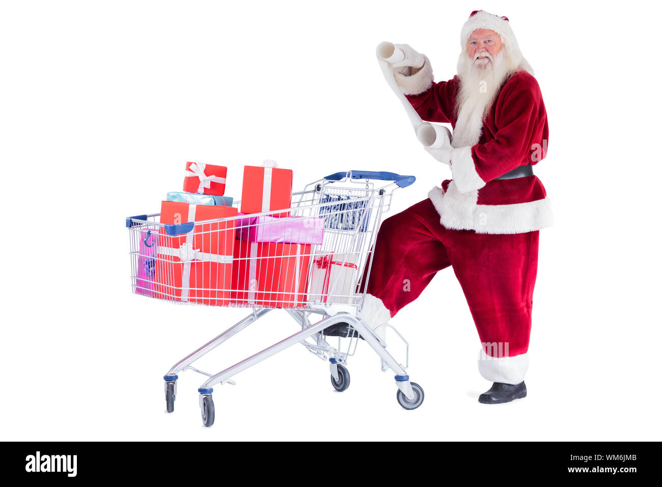 Santa pushes a shopping cart while reading on white background Stock Photo