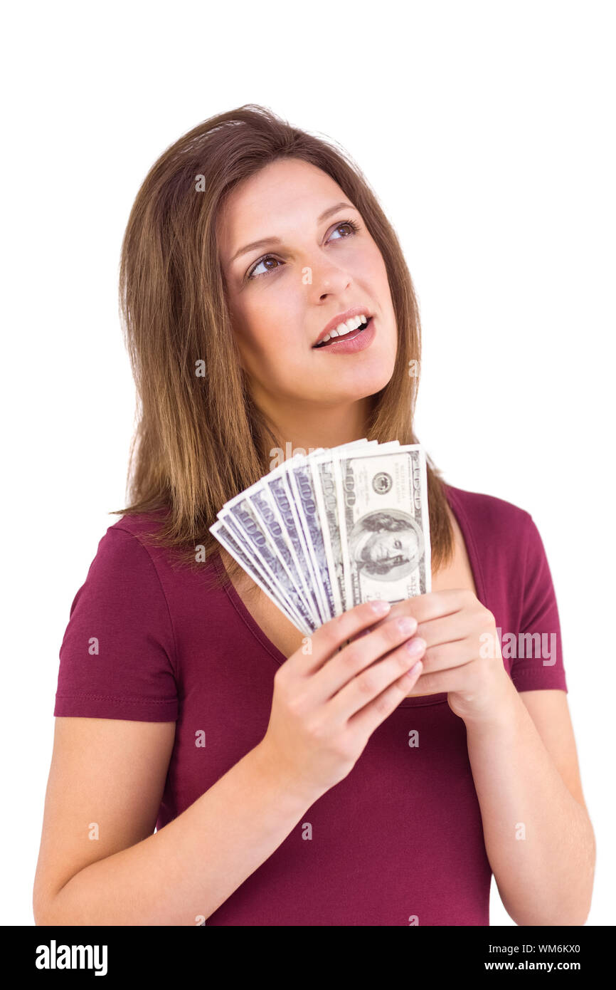 Festive brunette holding her cash on white background Stock Photo - Alamy