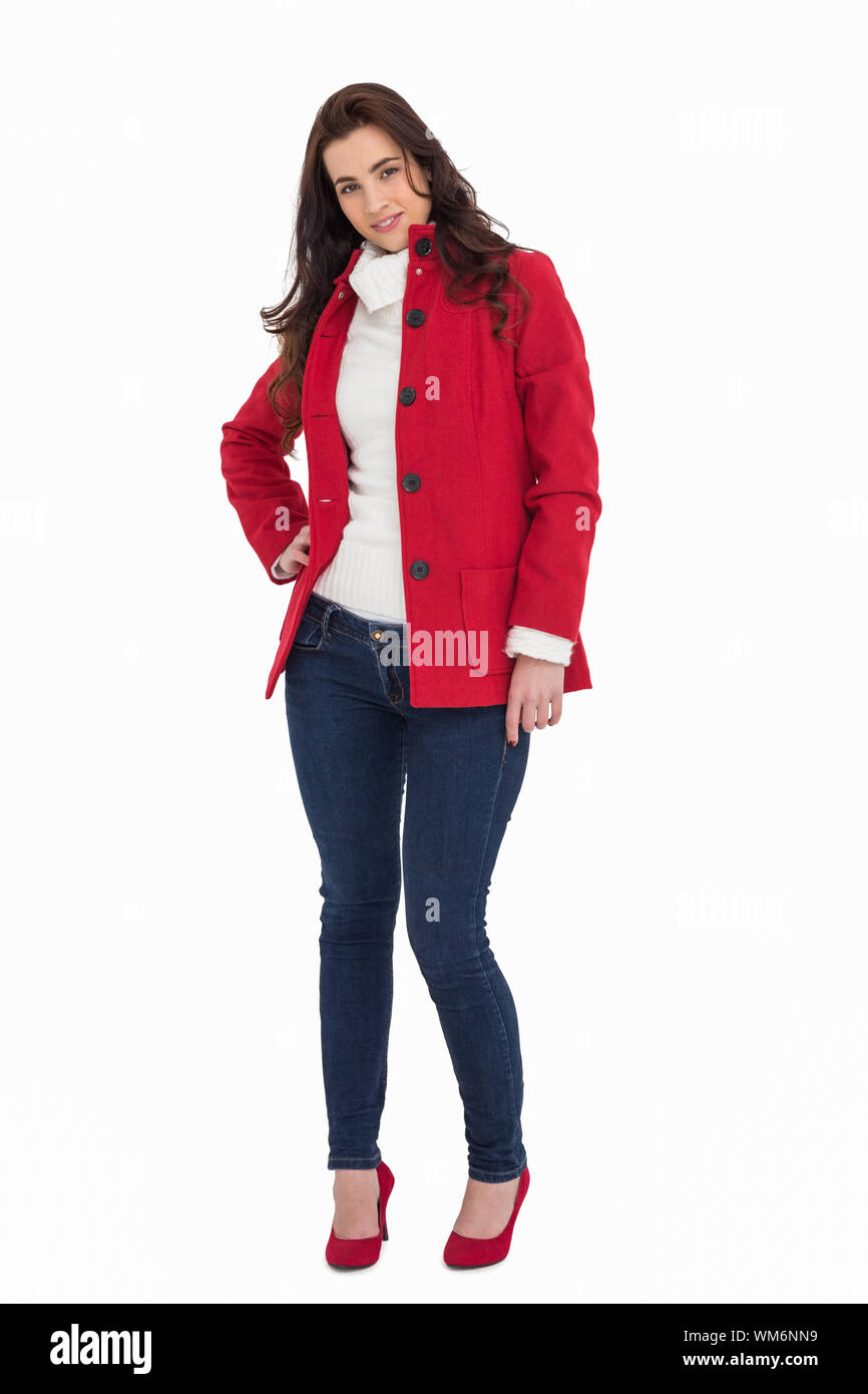Beauty brunette posing in red coat and heels on white background Stock Photo