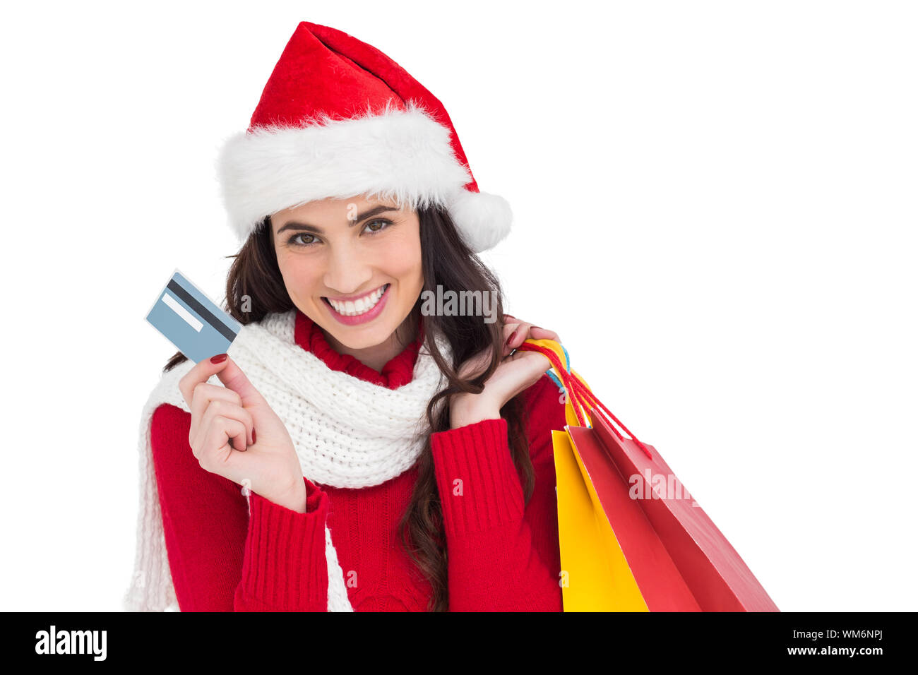 Excited brunette holding shopping bags and credit card on white ...