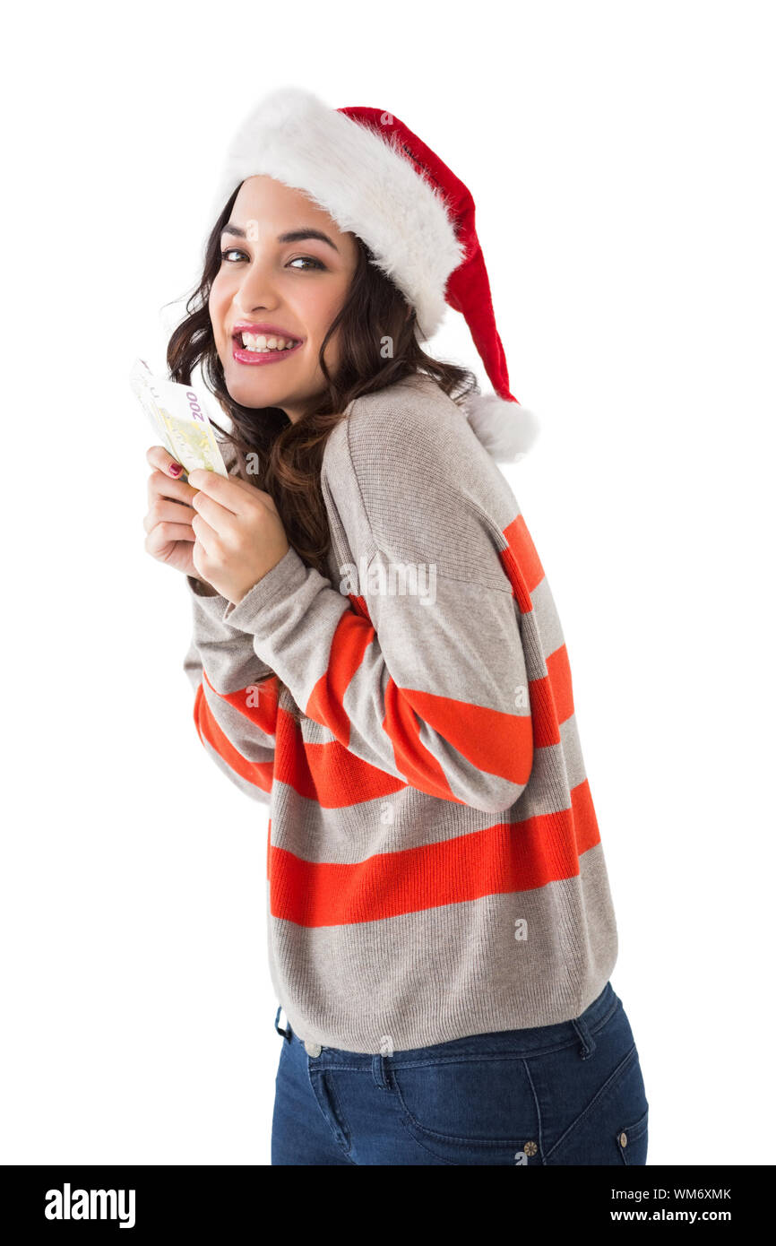 Happy brunette holding her cash on white background Stock Photo - Alamy