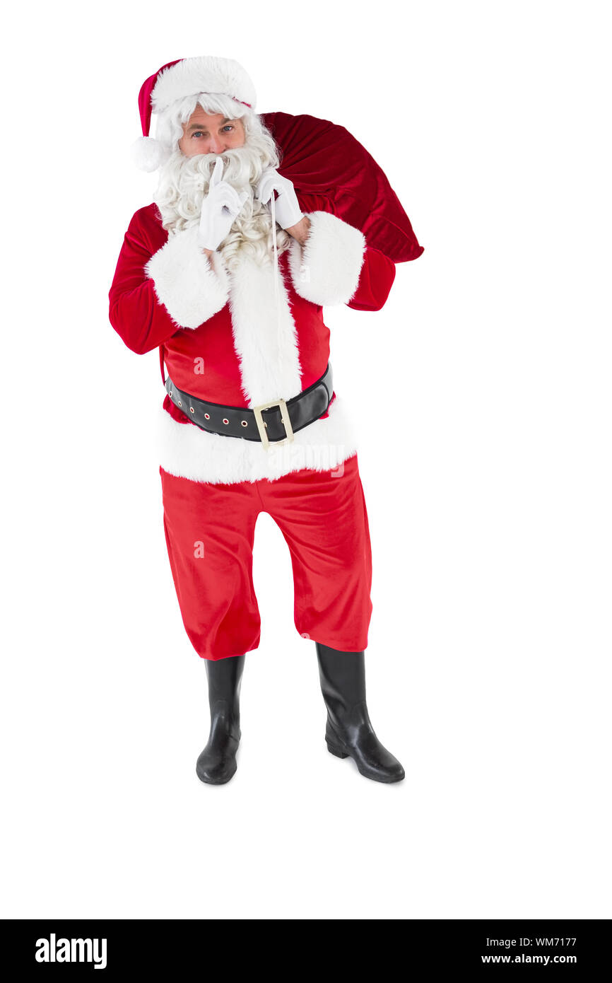 Santa holding sack and keeping a secret on white background Stock Photo ...