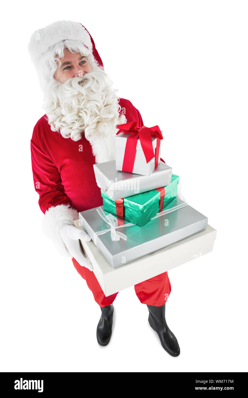 Happy santa claus holding pile of gifts on white background Stock Photo ...