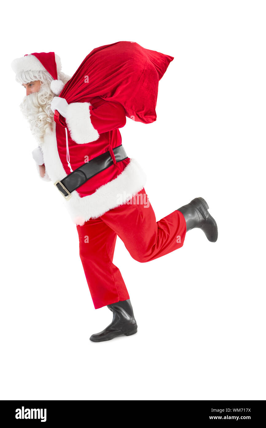 Santa claus walking with a sack on white background Stock Photo - Alamy