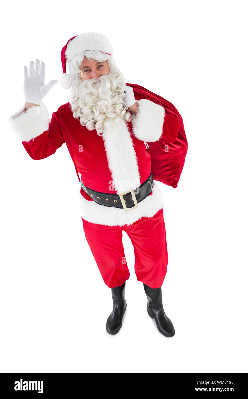 Santa holding a sack and waving on white background Stock Photo - Alamy