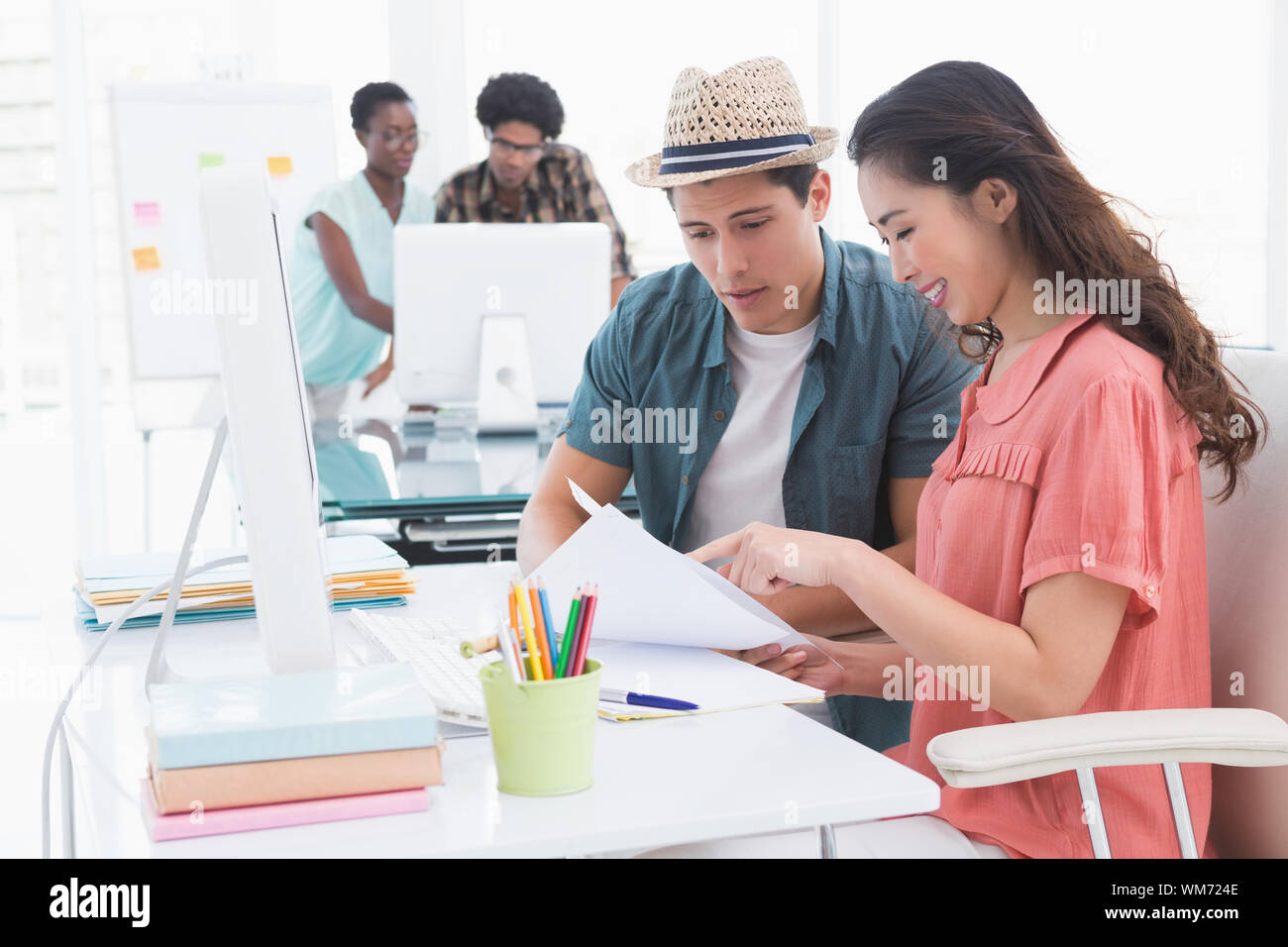 Young creative team working at desk in creative office Stock Photo - Alamy