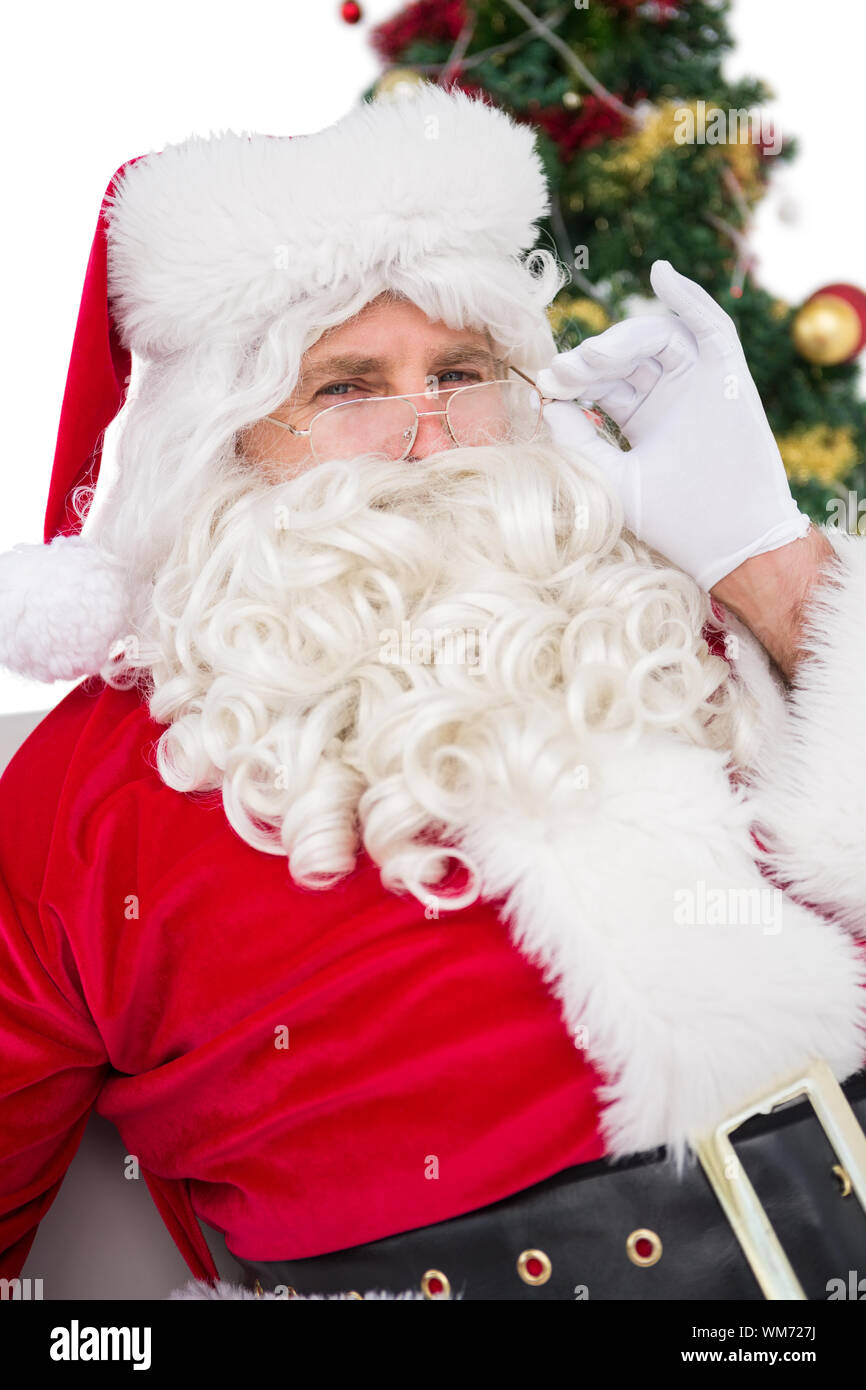 Santa claus sitting on a couch on white background Stock Photo