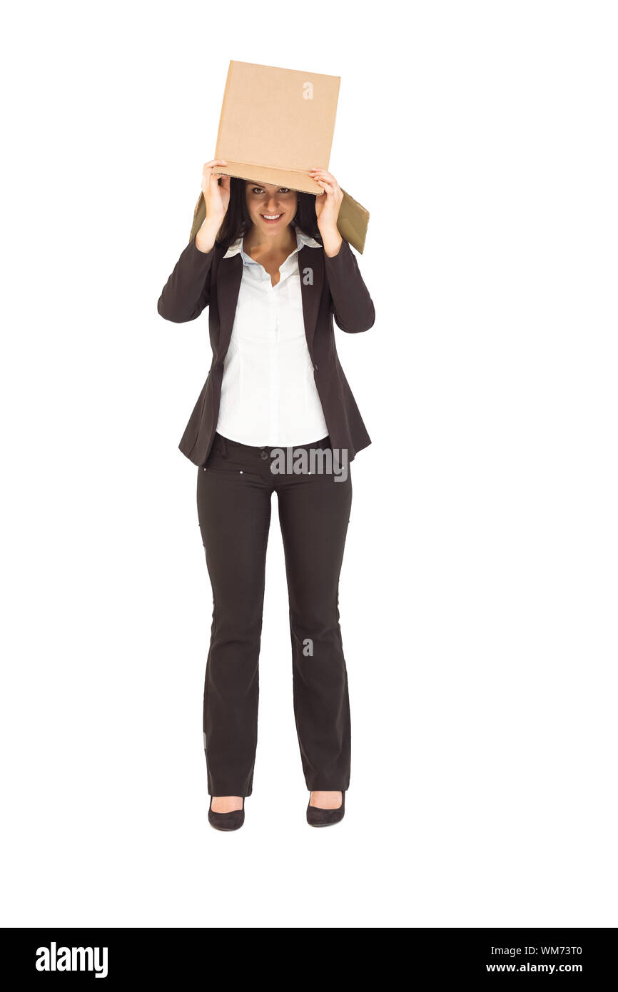 Businesswoman lifting box off head on white background Stock Photo