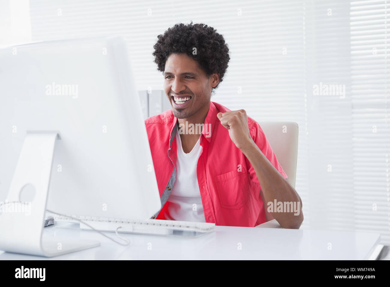 Mixed race man cheering office hi-res stock photography and images - Alamy