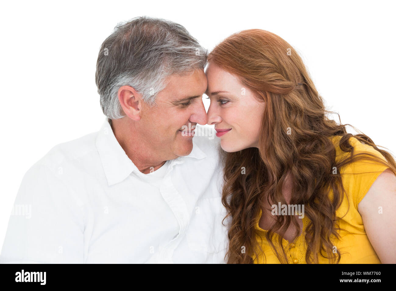 Casual couple smiling at each other on white background Stock Photo - Alamy