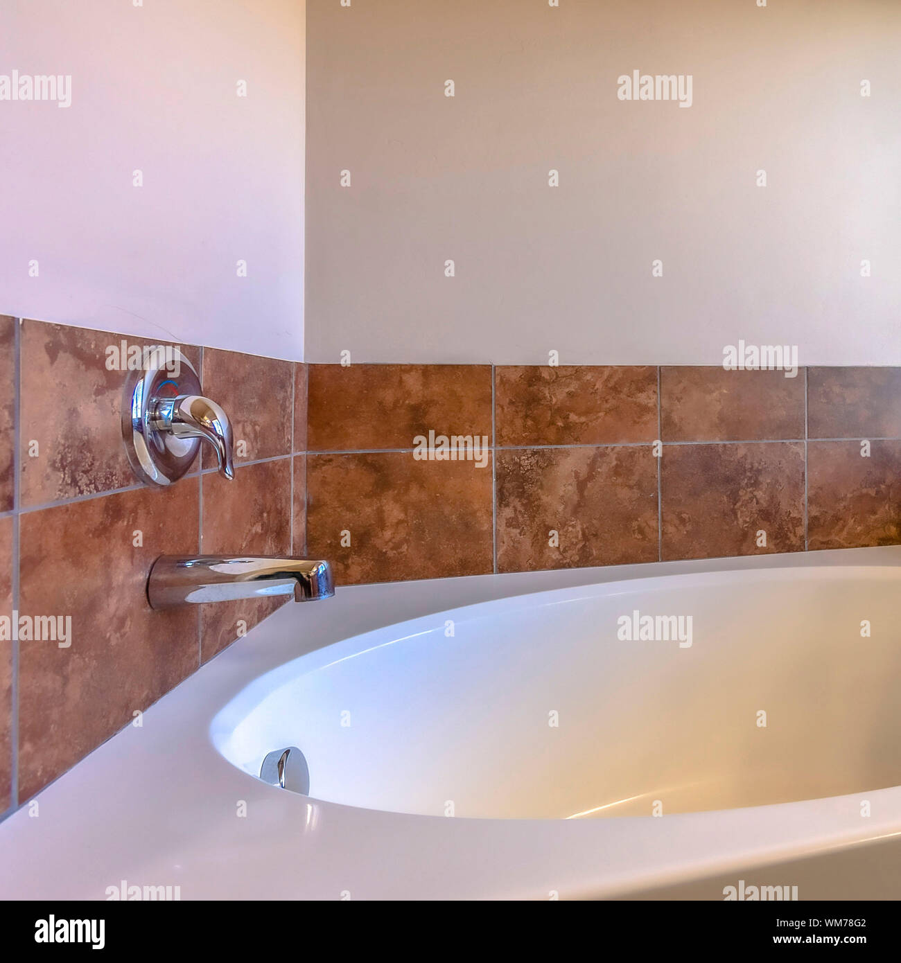 Square Close up of built in oval bathtub inside a bathroom with tiled