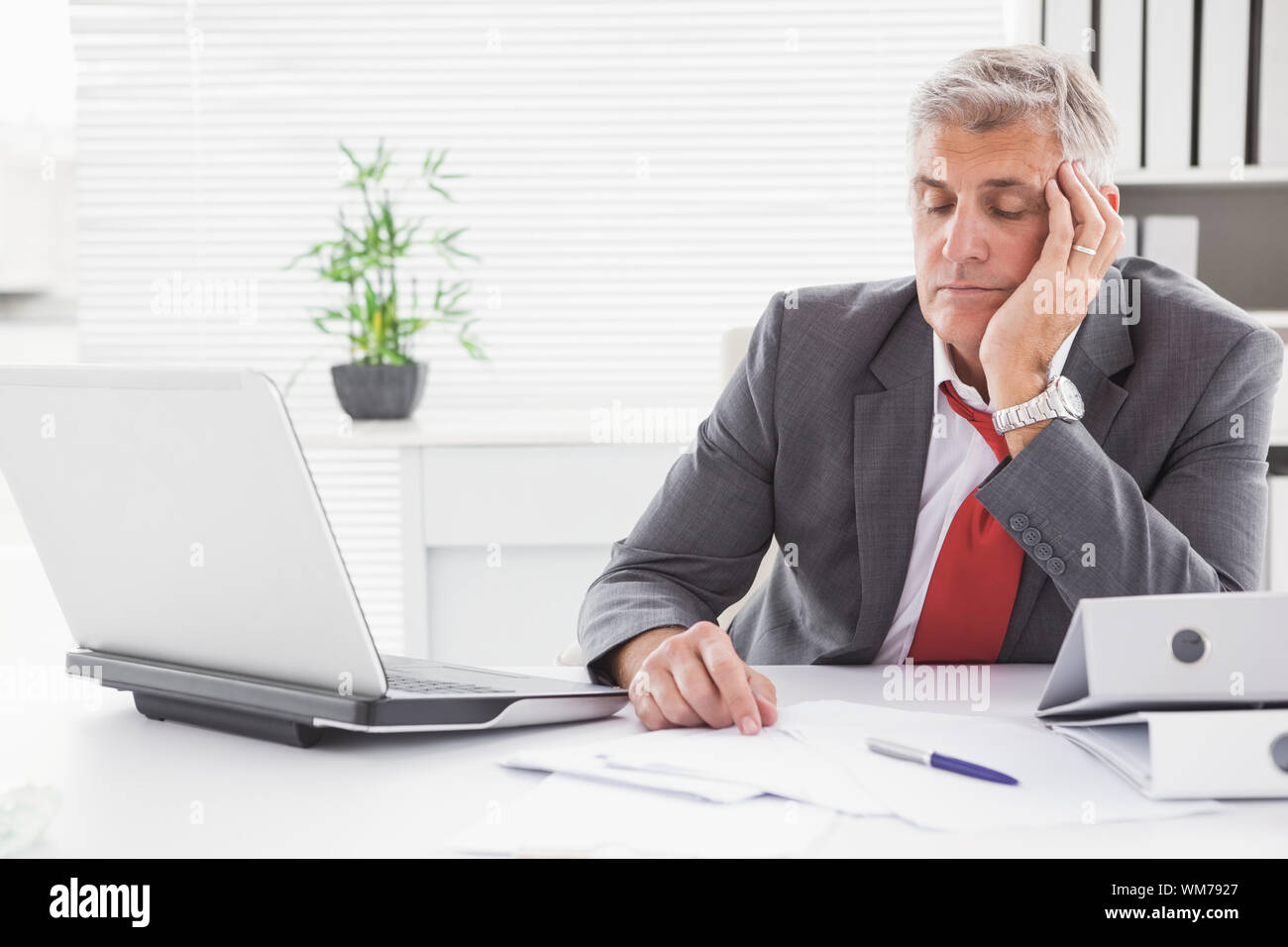 Tired Businessman Falling Asleep At Desk In His Office Stock Photo