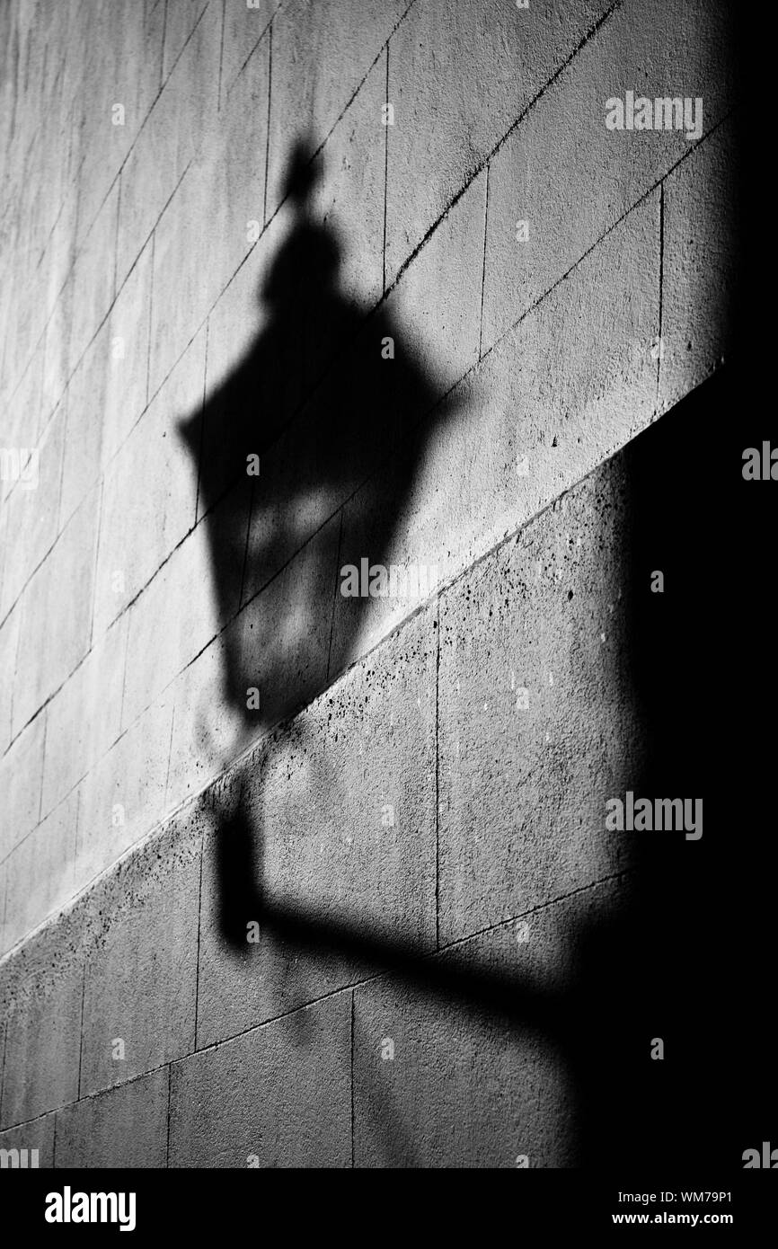 Street Light Shadow On Wall At Night Stock Photo