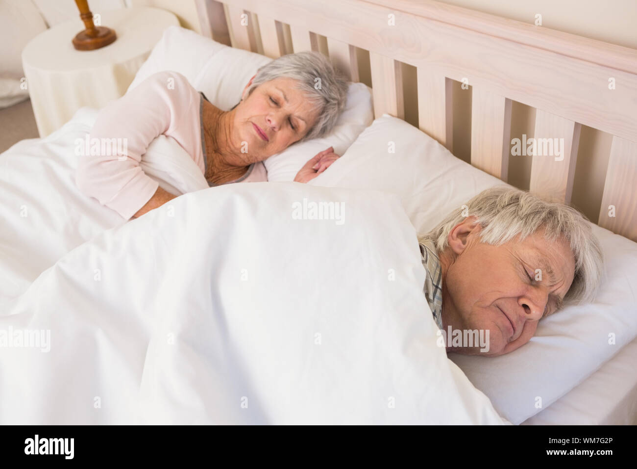 Senior couple sleeping in bed at home in the bedroom Stock Photo - Alamy