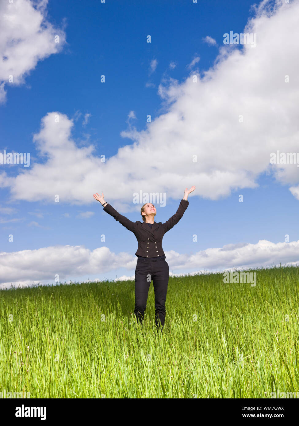 Young woman with her arms raised outdoor Stock Photo - Alamy