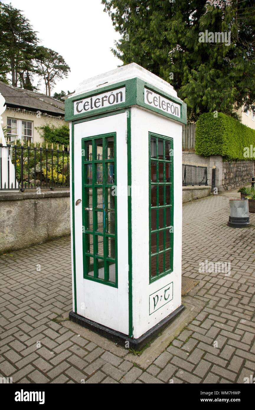 irish white and green phone box at the street Stock Photo