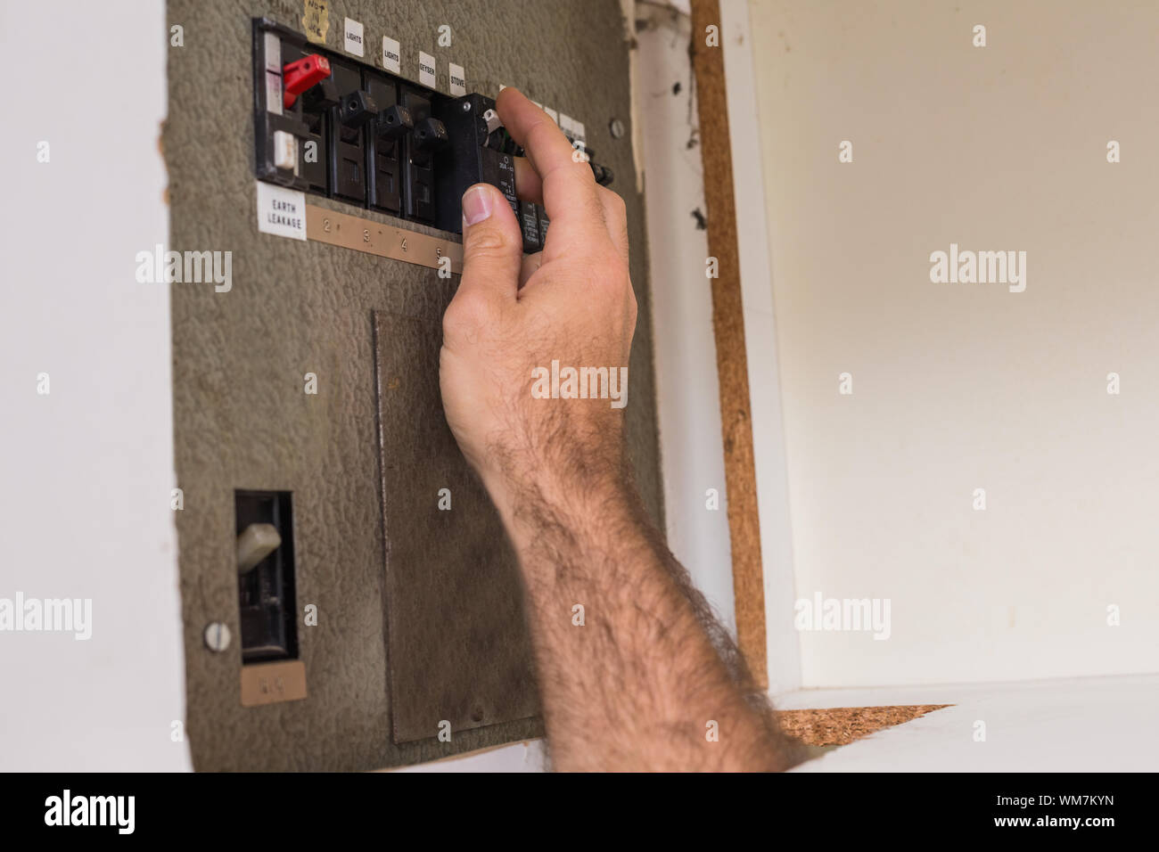 Electrician working on the fuse box in the kitchen Stock Photo Alamy