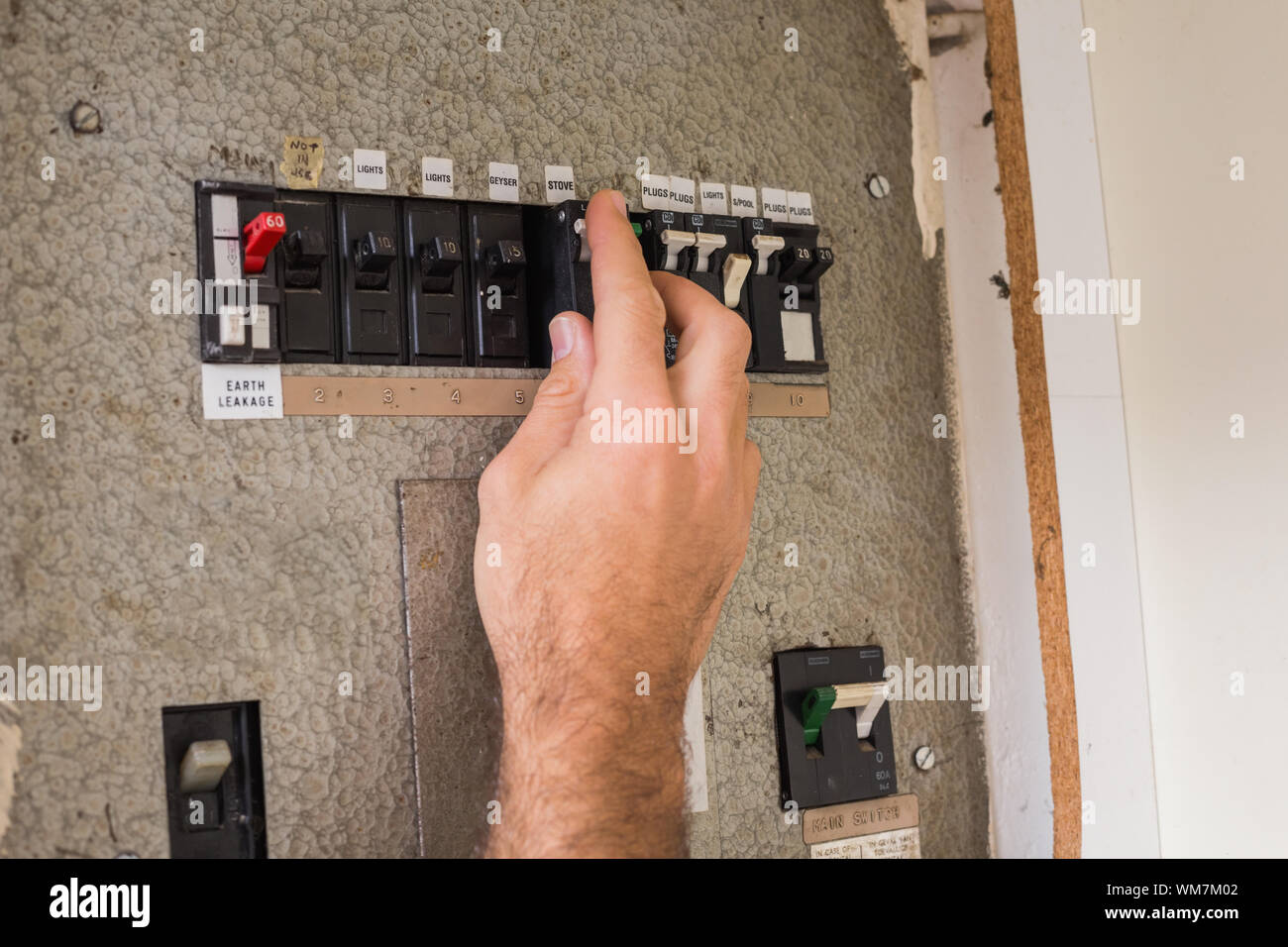 Electrician working on the fuse box in the kitchen Stock Photo Alamy