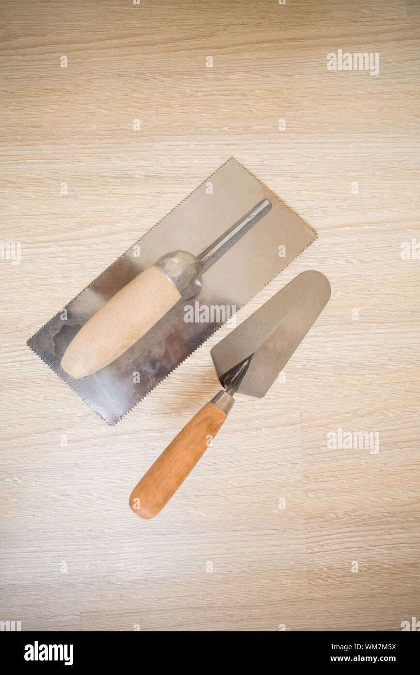 Overhead of trowel and spade on wooden floor Stock Photo Alamy