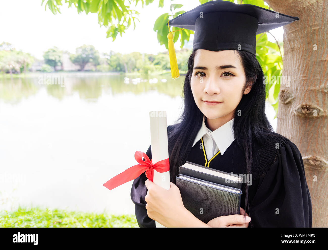 Beautiful asian women graduating holding diploma with pride and smiling in ...