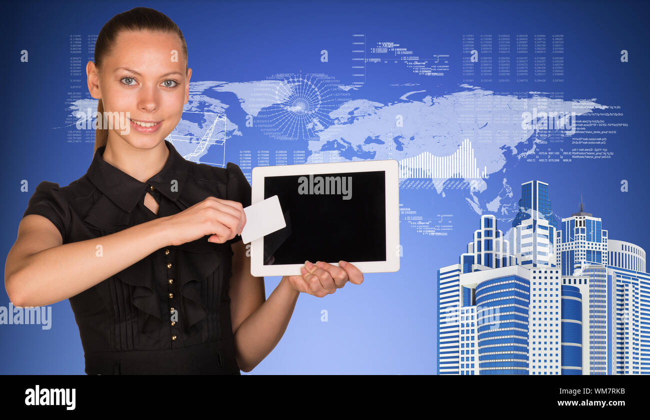 Beautiful businesswoman holding blank tablet PC and blank business card in front of PC screen. Skyscrapers, world map, hi-tech graphs with various dat Stock Photo