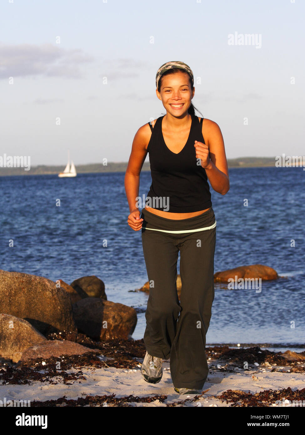 Woman running on a beach Stock Photo Alamy