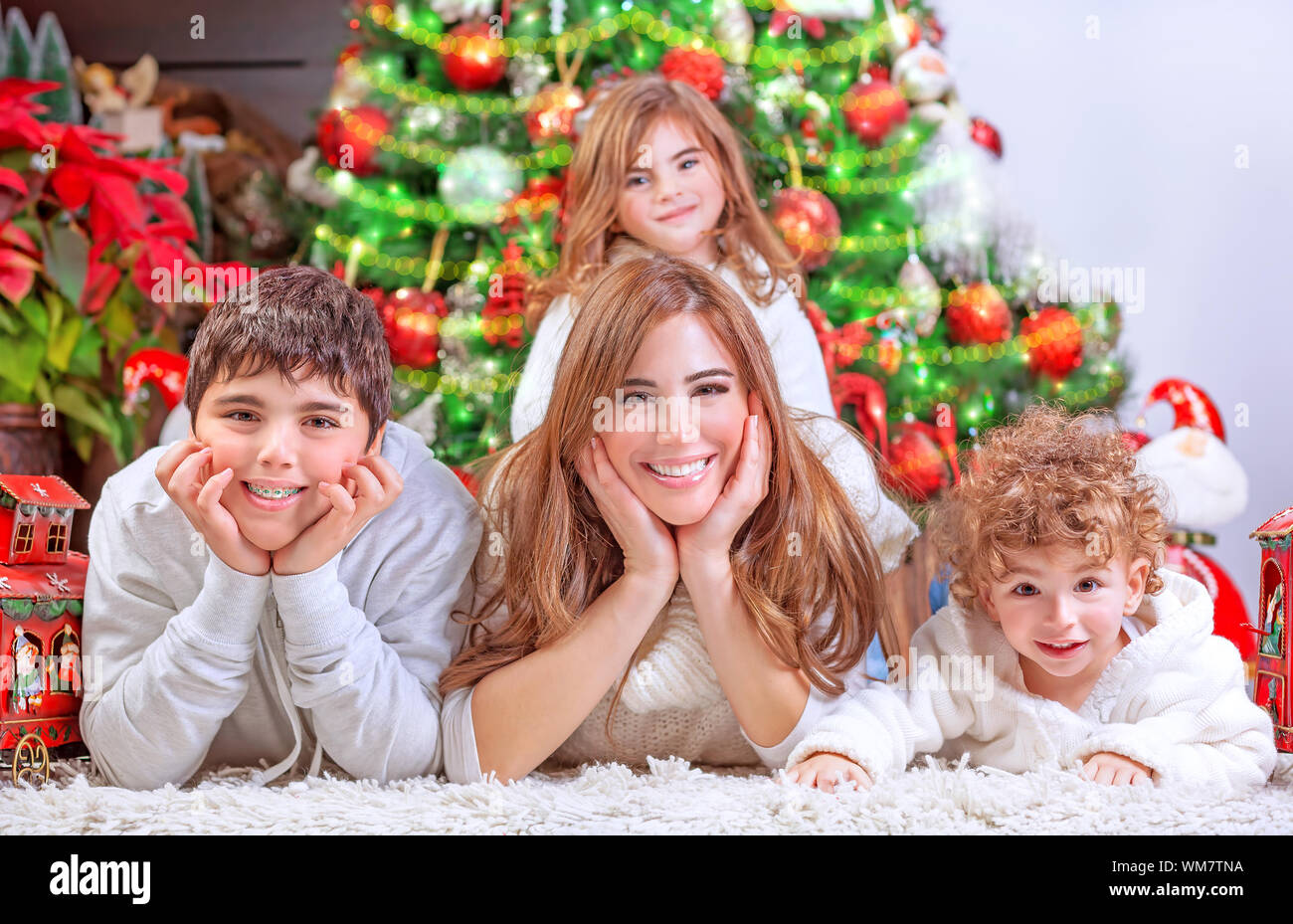 Happy Christmas celebration, cheerful family having fun at home, lying ...