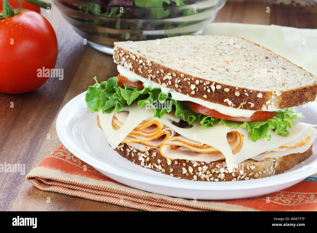 Smoked chicken sandwich with lettuce, tomato and swiss cheese and whole