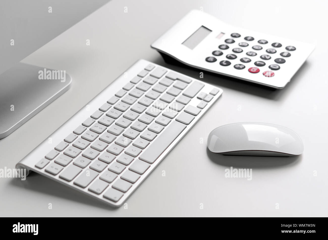 White Desk With Computer Keyboard Mouse And Calculator With