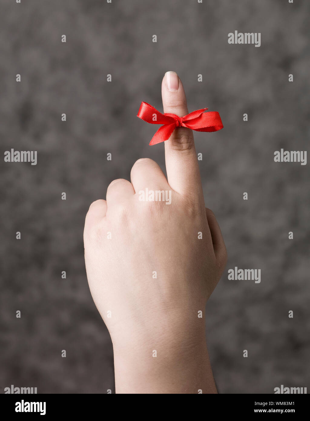 Red string around the finger as a reminder Stock Photo Alamy