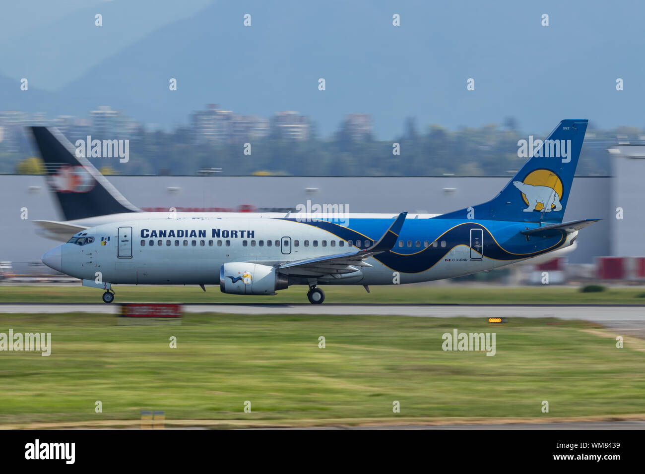 Canadian North (Airlines) Boeing 737 taking off from Vancouver Intl. Airport on a sunny day. Stock Photo