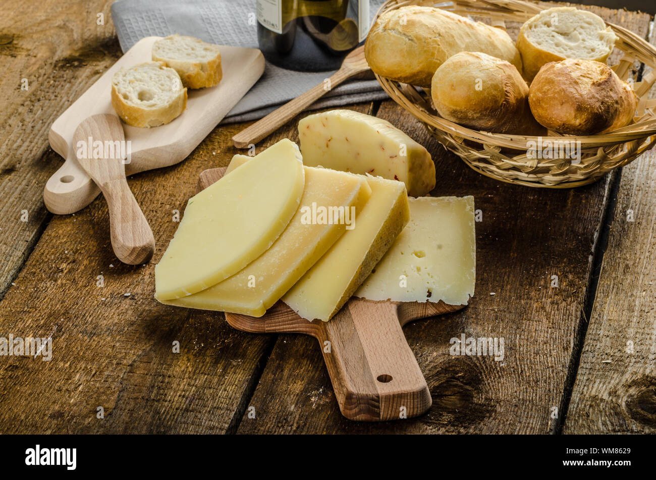 Delicious ripe cheese with crispy baguette and wine, wood board Stock ...