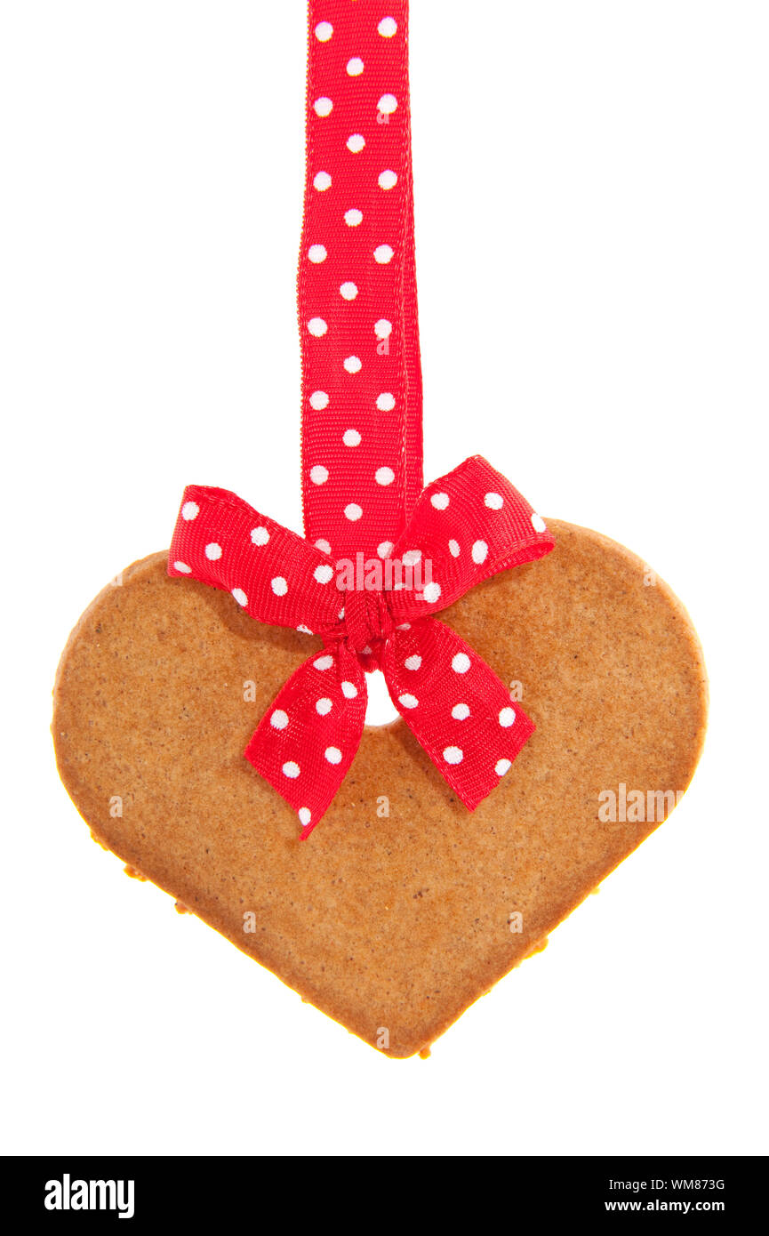 Baked gingerbread heart with red speckles bows and ribbon Stock Photo