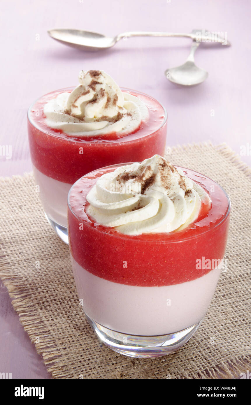 strawberry mousse with pudding, whipped cream and cocoa powder in a