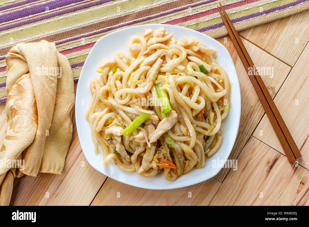Pan fried Japanese udon noodles in garlic sauce with chicken Stock