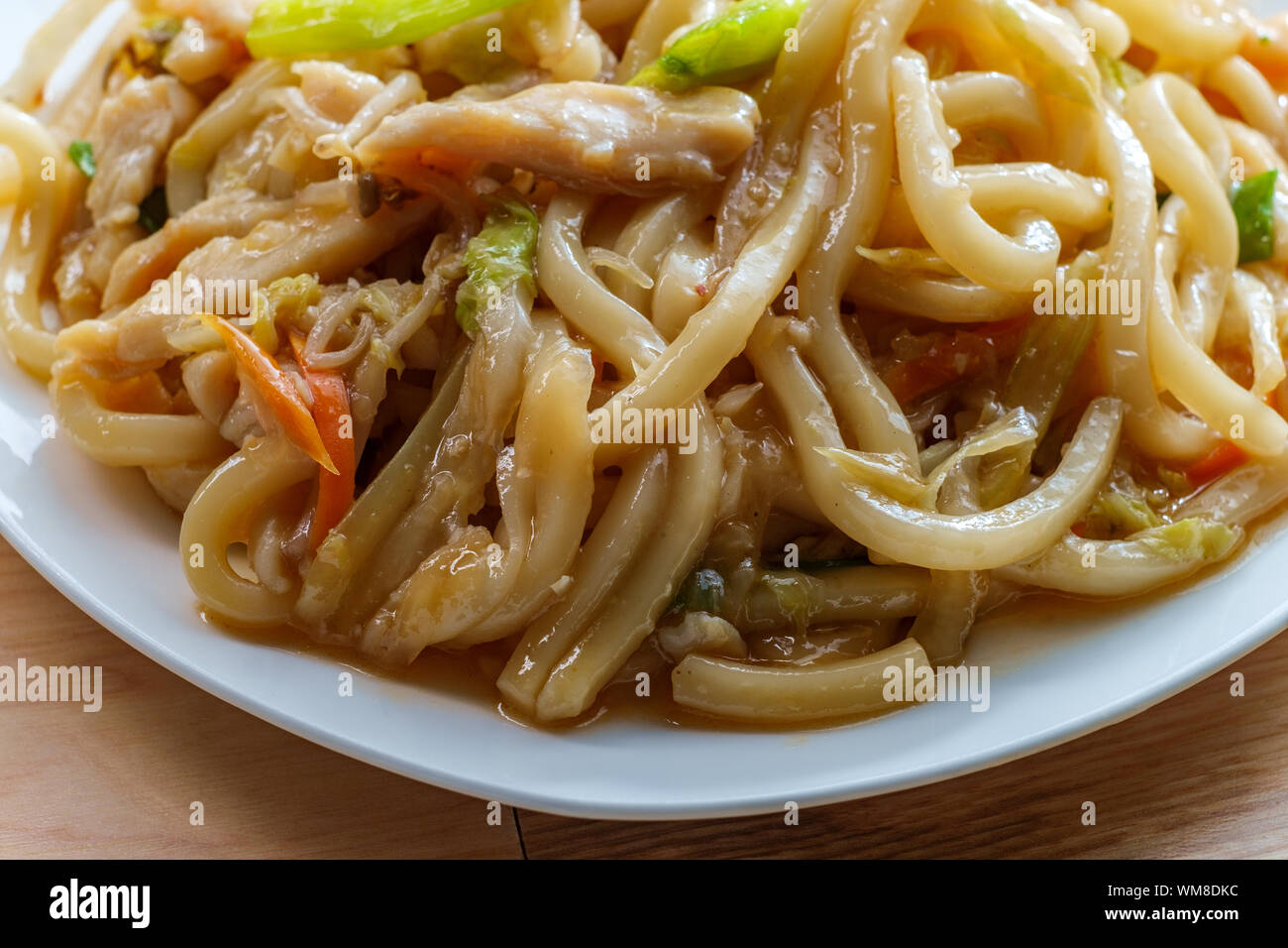 Pan fried Japanese udon noodles in garlic sauce with chicken Stock