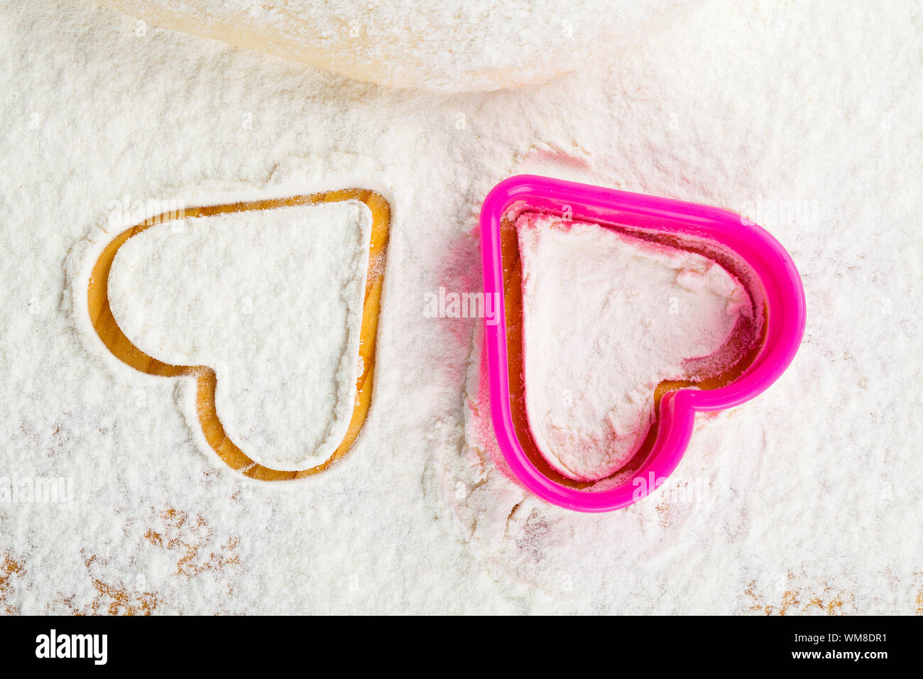 heart shaped cookie cutter on flour Stock Photo