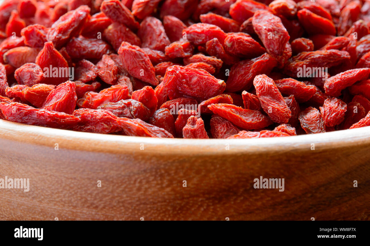 Wooden Bowl Full of Dried Goji Berries. Healthy Diet Stock Photo