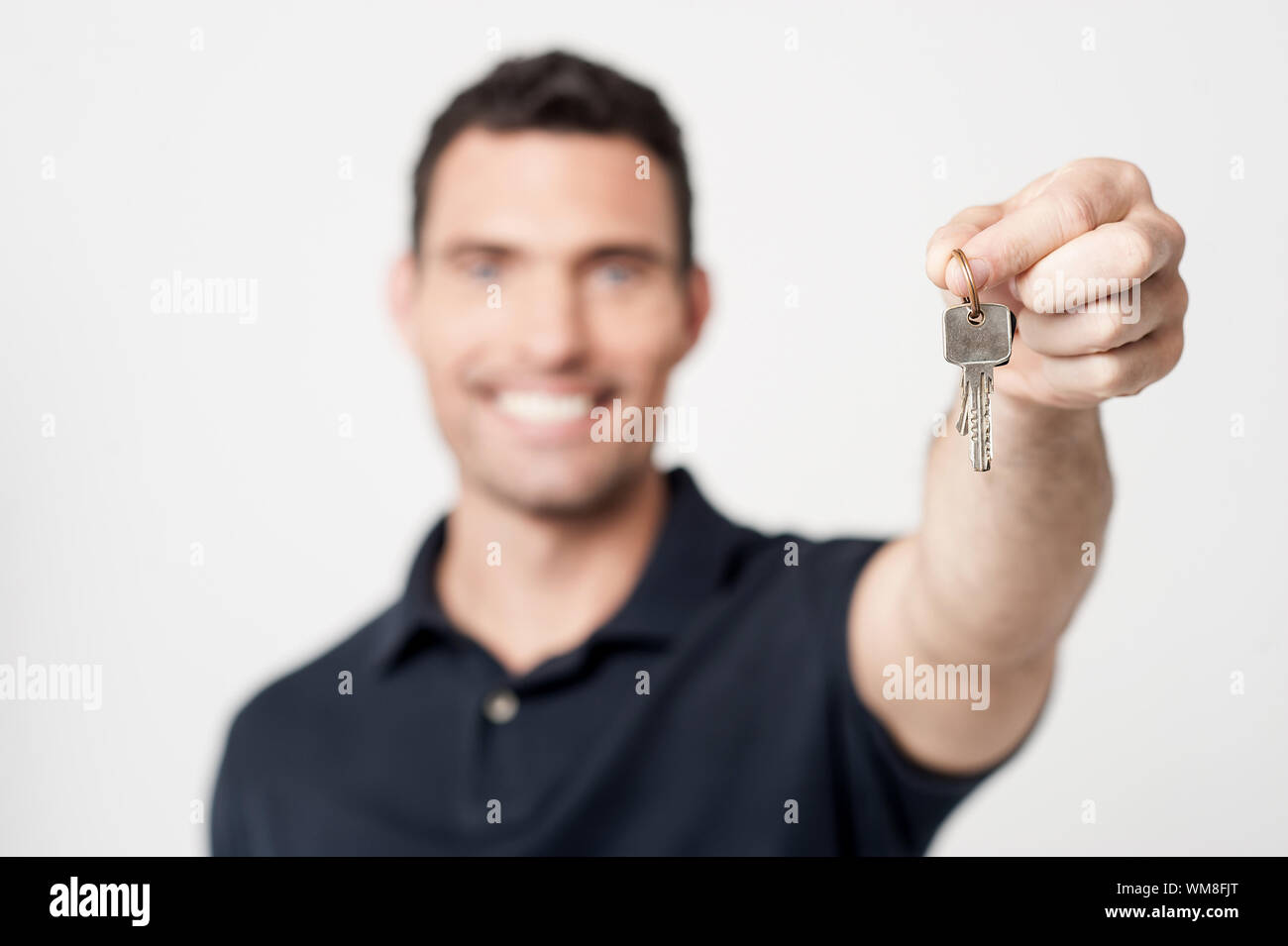 Real estate agent showing new house key Stock Photo Alamy