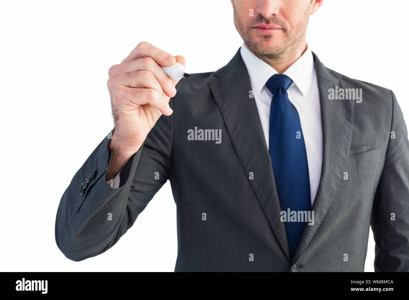 Serious businessman writing with marker on white background Stock Photo ...