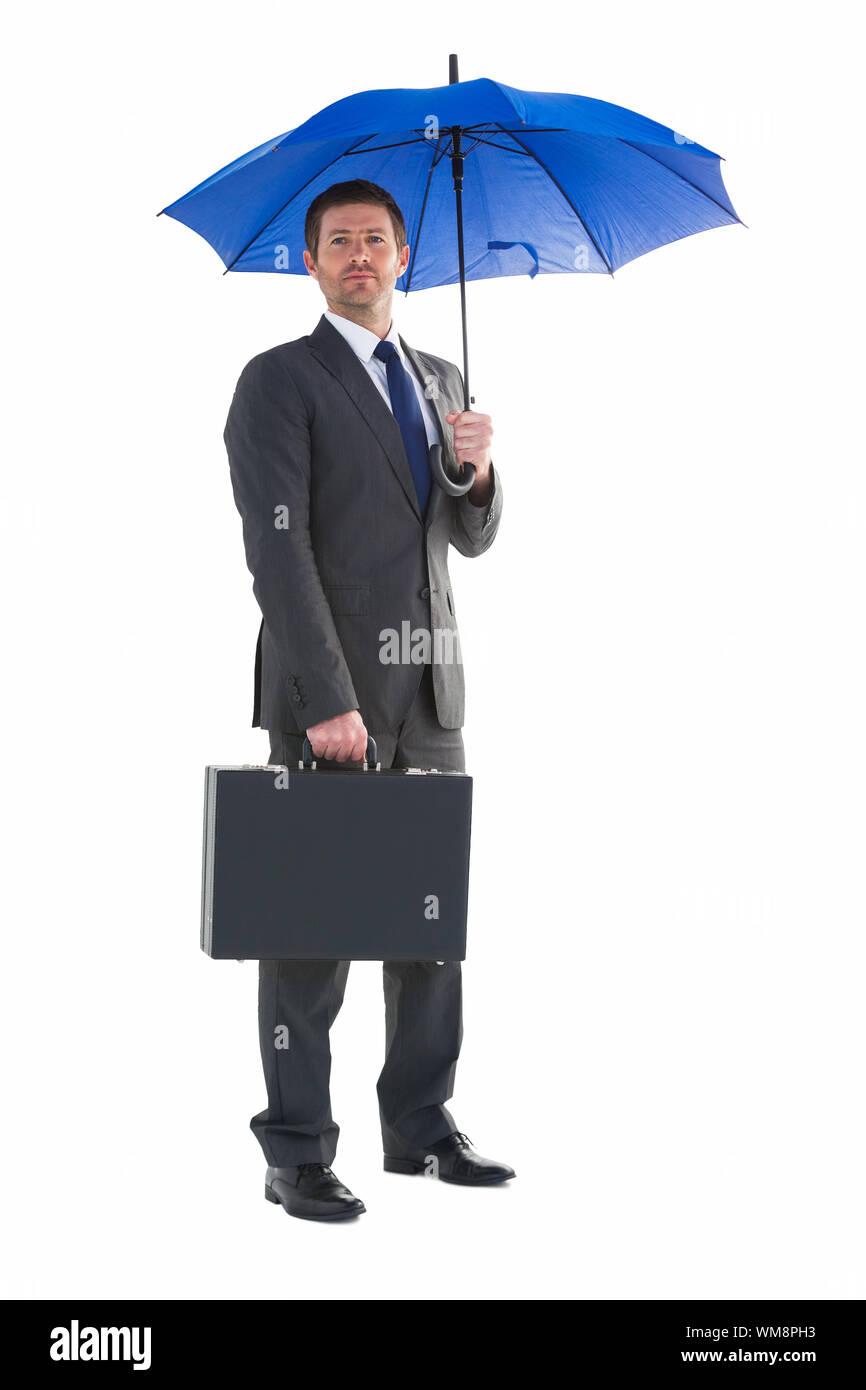 Serious businessman holding his umbrella and briefcase on white background Stock Photo Alamy