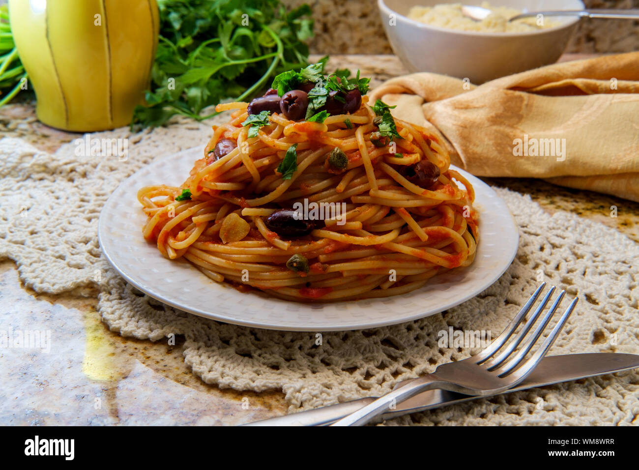 Delicious Italian spaghetti alla puttanesca with kalamata olives and capers Stock Photo