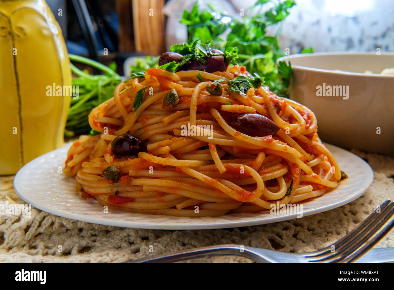 Delicious Italian spaghetti alla puttanesca with kalamata olives and