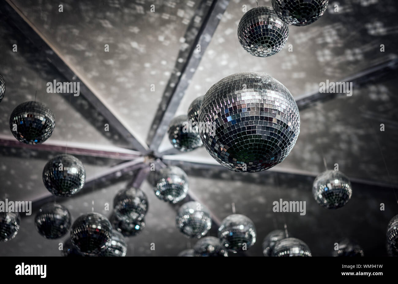 Low Angle View Of Disco Balls Hanging From Ceiling Stock