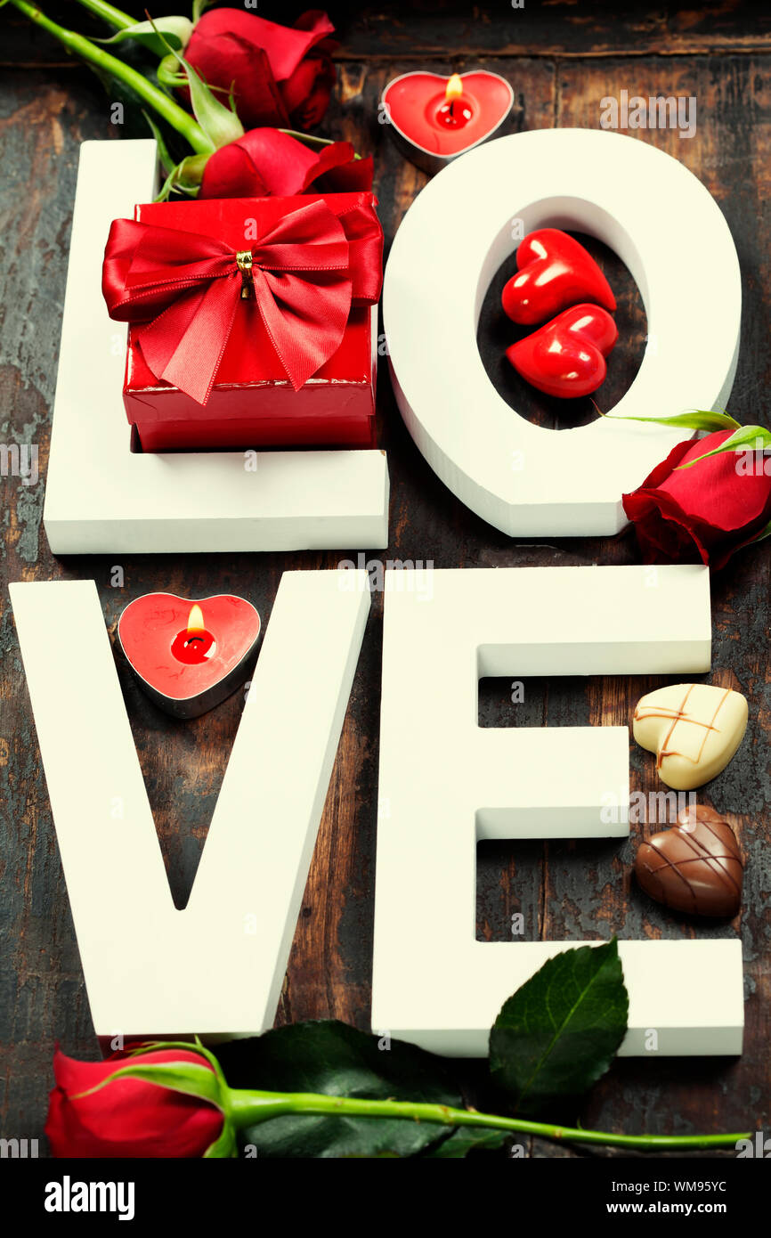 Wooden letters forming word LOVE on wooden background Stock Photo - Alamy