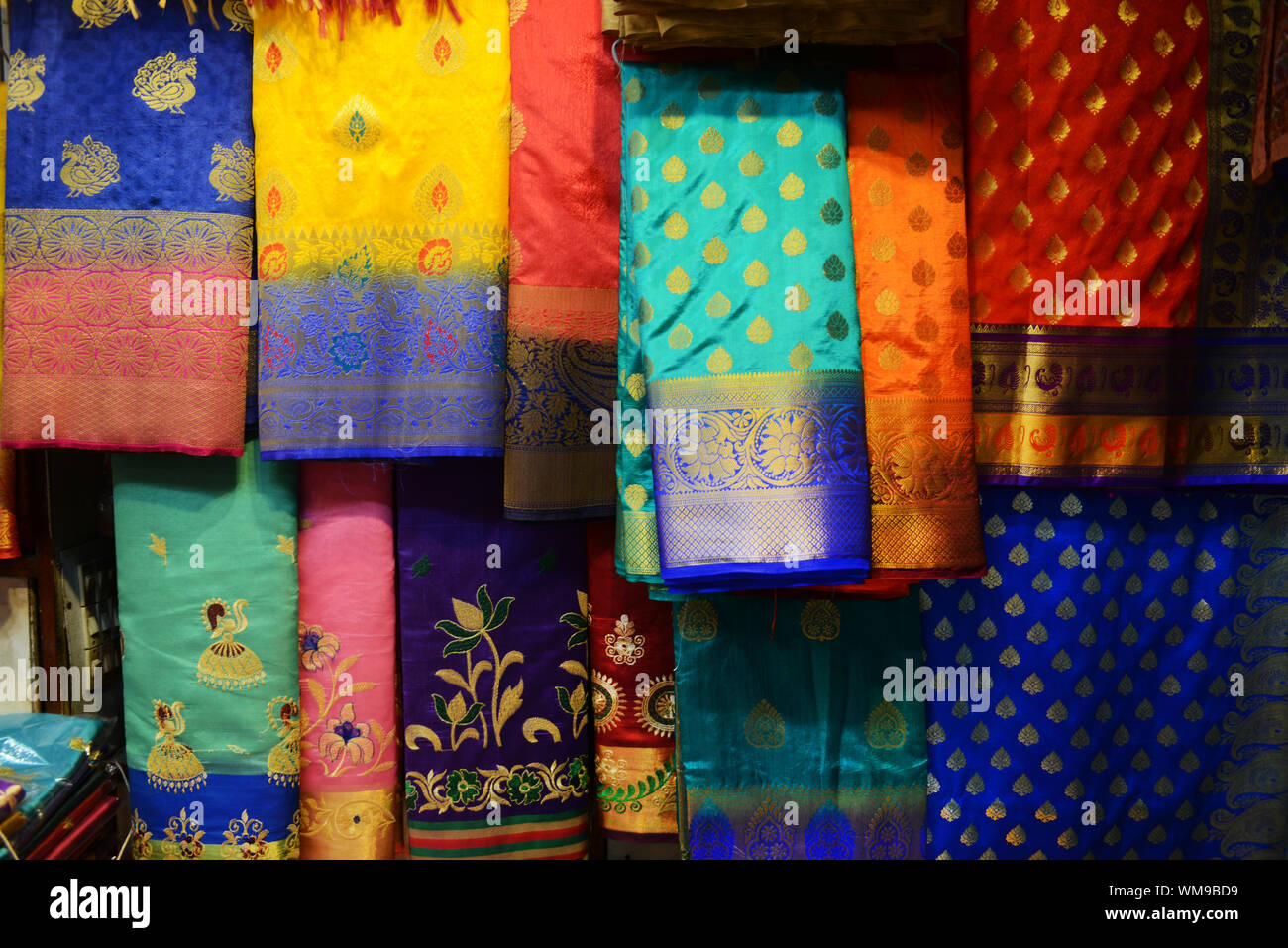 colorful sarees displayed in a shop in varanasi india WM9BD9