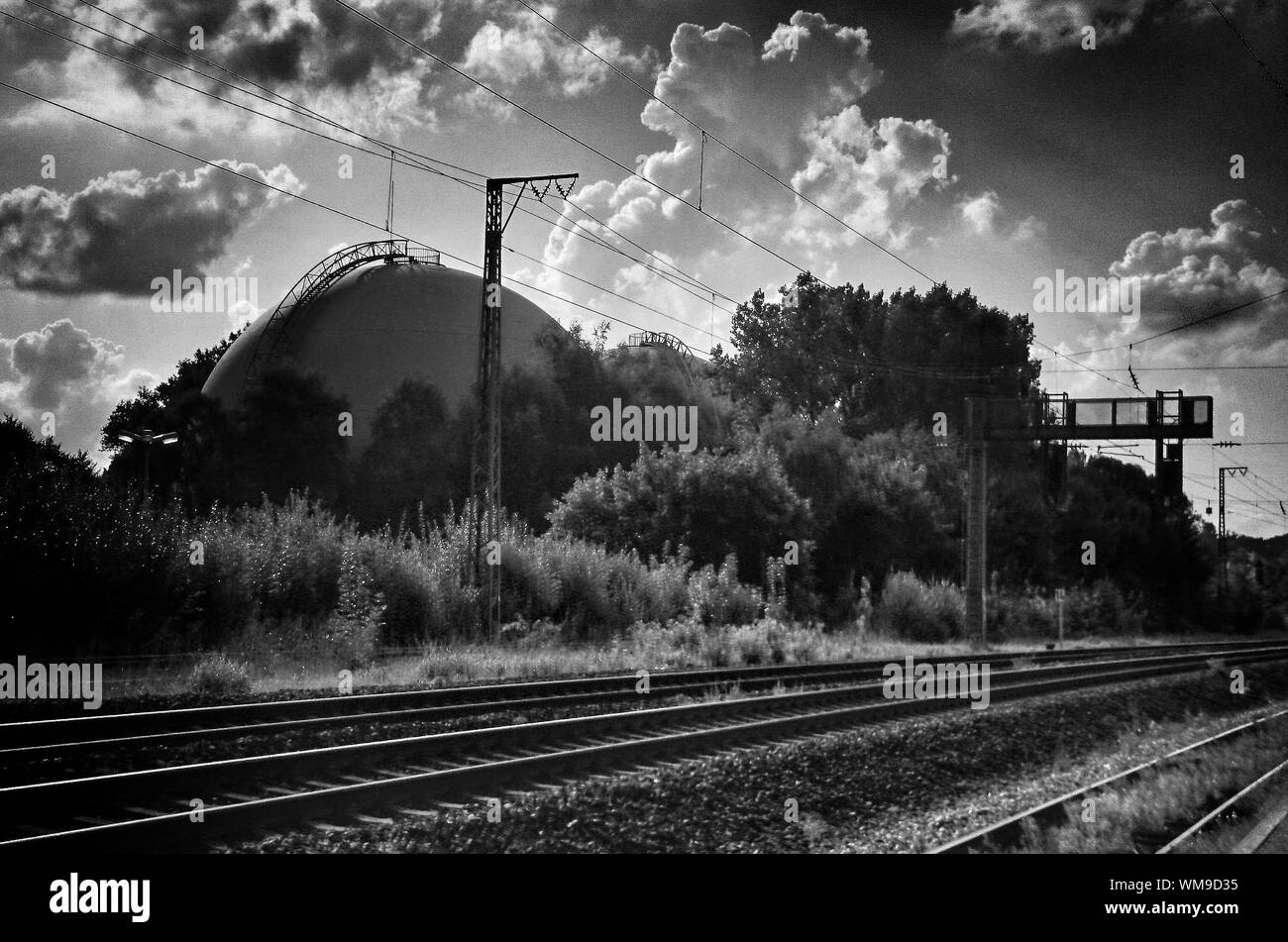 Railroad Tracks And Gasworks Dresden-reick Against Cloudy Sky Stock Photo
